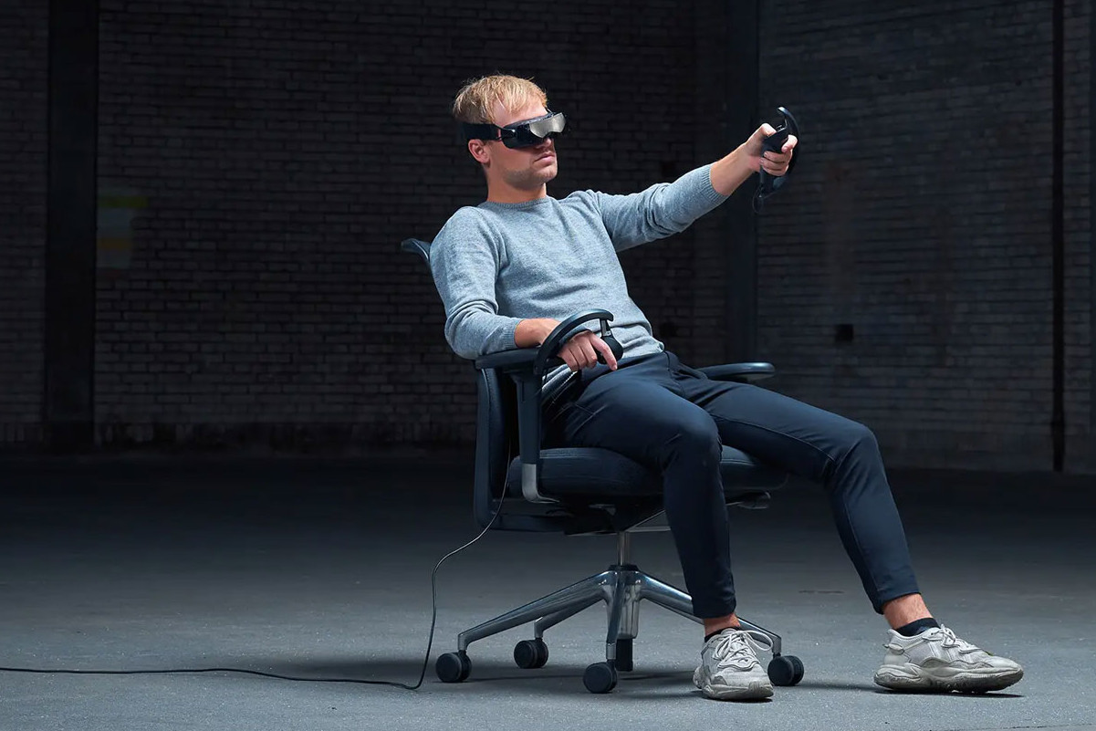 Bigscreen Beyond VR headset sitting in chair with tethered wire