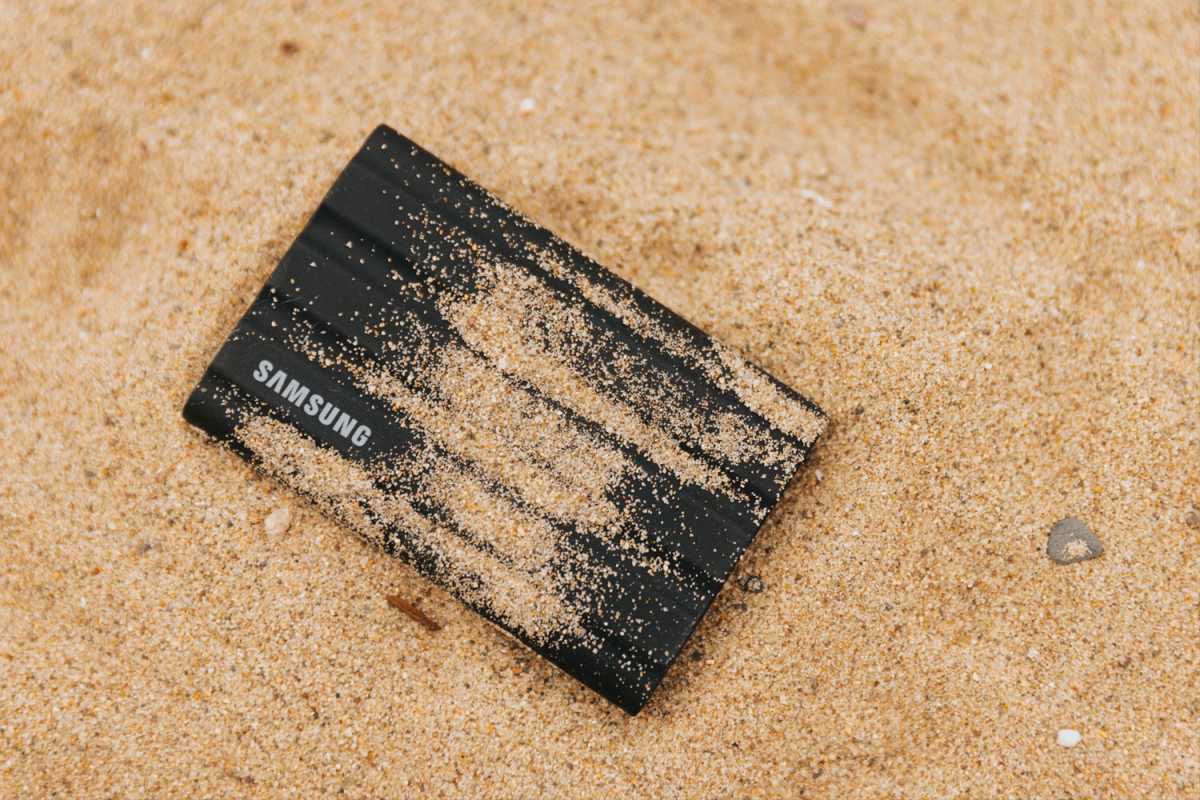 Samsung portable SSD covered in sand on the beach