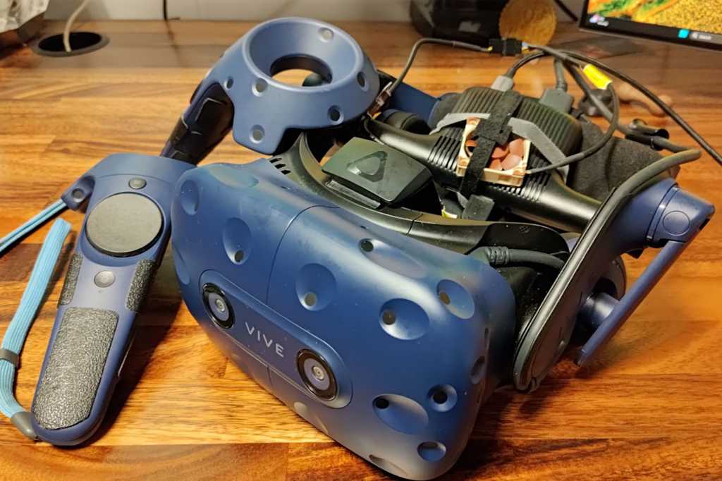 Vive Pro VR headset with controllers on wooden desk